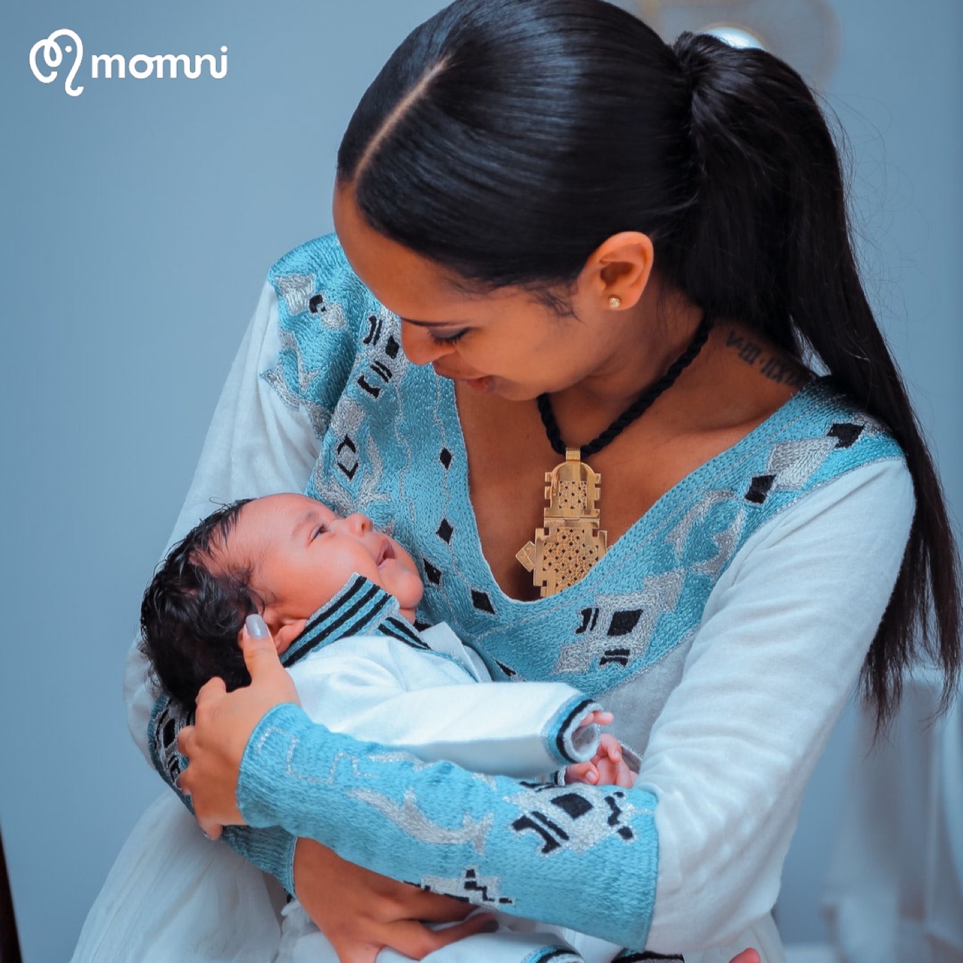 A mama cradling her newborn close